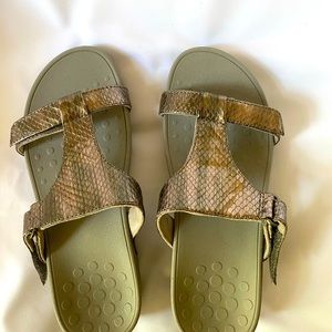 Vionics strap wedge sandals with Bronze snakeskin above a grey wedge.